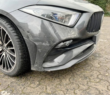 mercedes car from the front right. Damage on the bottom part of the car.